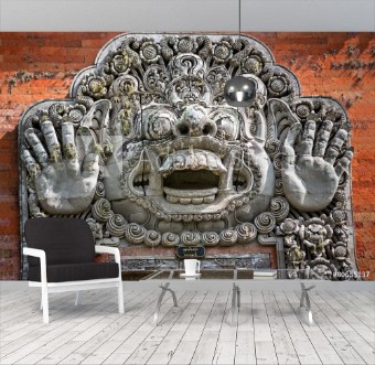 Picture of Carvings depicting demons or gods above the entrance to the temp